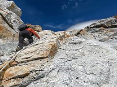09B Climbing the steepest section of the rocky boulder slabs with hand ropes on the way to Lobuche East High Camp 5600m